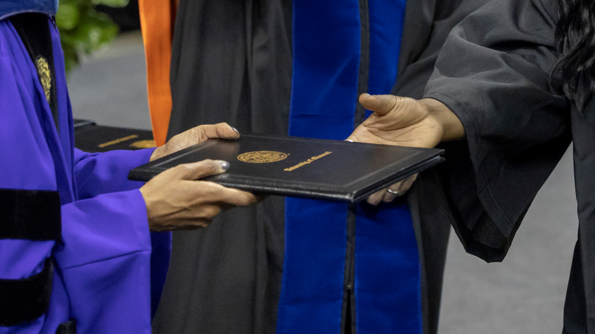 diploma being handed to graduating student