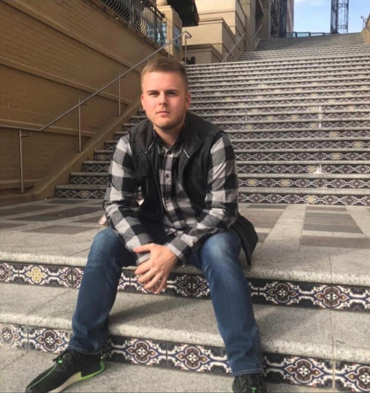 Kyle Bals sitting on stairway 
