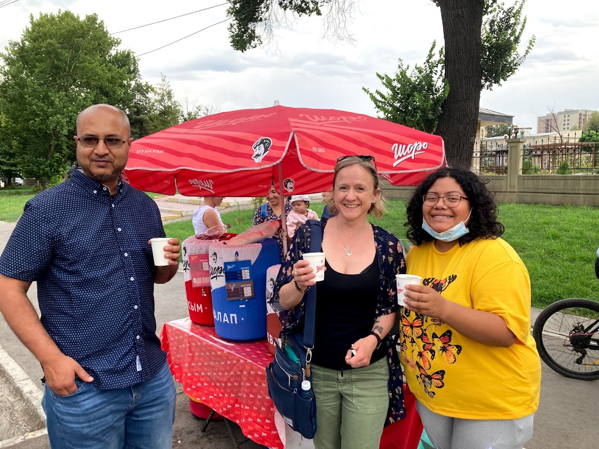 Photo of trip-goers sampling a local beverage in Bishkek - Yasir Khan, Lindal Sambrook, Edith Ramirez-Salazar