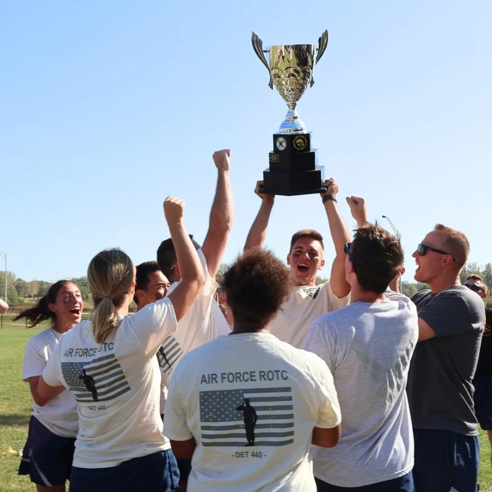 Cadets hold their trophy in the air