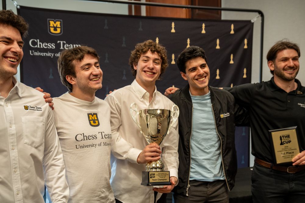 Mizzou Chess Team holding trophy after winning championship. 