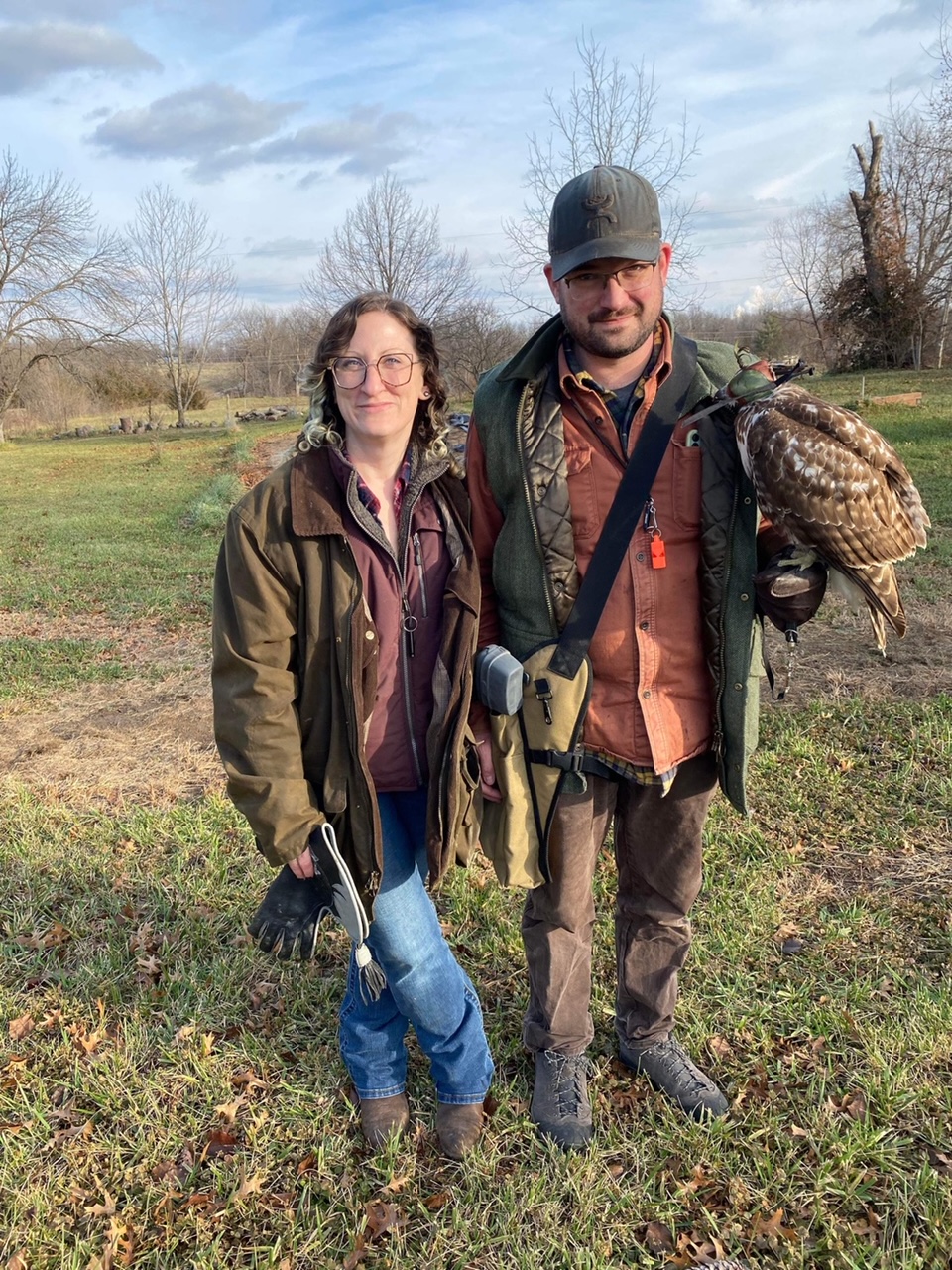 Falconers Sara Wolff and Jackson Kendrick with his juvenile redtailed hawk, Scarlett, at Midwest Eyries in Fulton, MO. Photo taken after Scarlett’s first free (untethered) flight in December 2021.