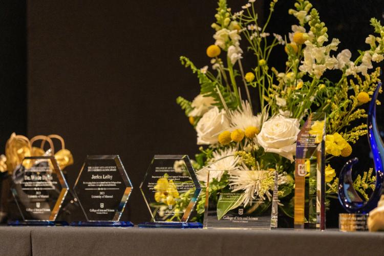 awards and flowers arranged on a table