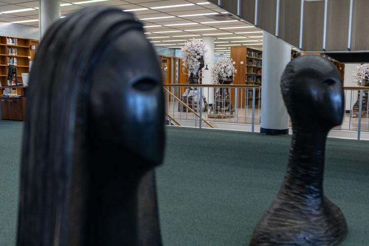 two tall sculptures in library