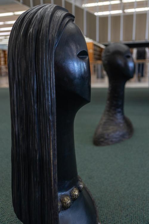 two tall sculptures in library