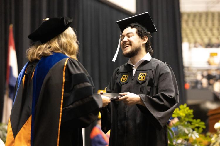 A photo of a student receiving their diploma