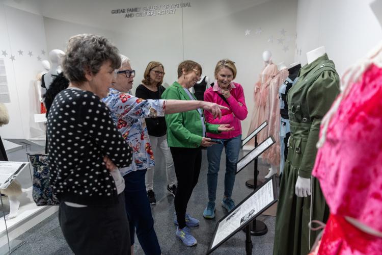 Visitors looking at fashion exhibit