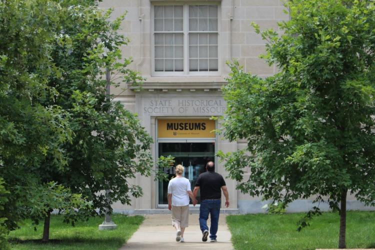 two people walking toward the museum entrance