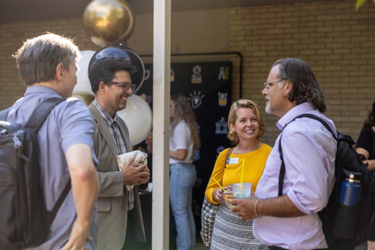 Attendees talk in group