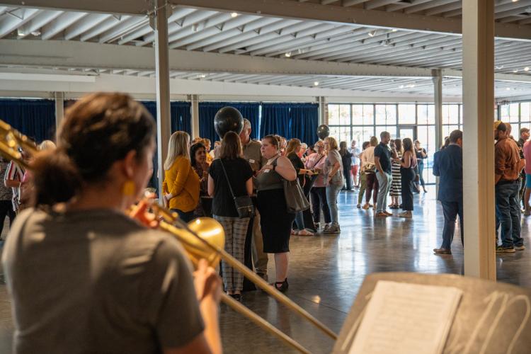 Musician plays trombone in front of crowd