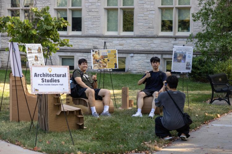 attendees test cardboard chairs