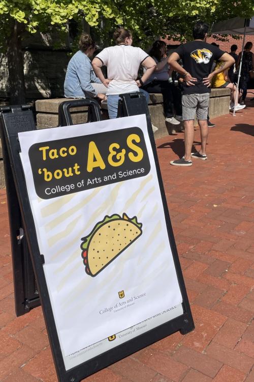 outdoor sign with picture of taco