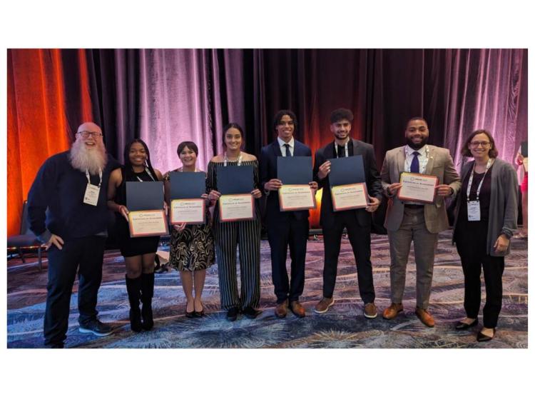 A photo of MARC team members (MARC students and Directors at ABRCMS conference 2023. Front row (from left): Undergraduate Director Brian Booton, Morgan Williams, Kassandra Ramos, Alyssa Fritz, Doniven Hicks, Ahmed Ebada, MARC alumnus Brendan Ball, and Program Director Dr. Elizabeth King).